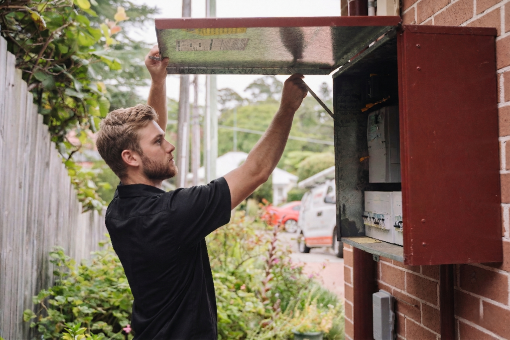 Electrician installing downlights in a Arncliffe home